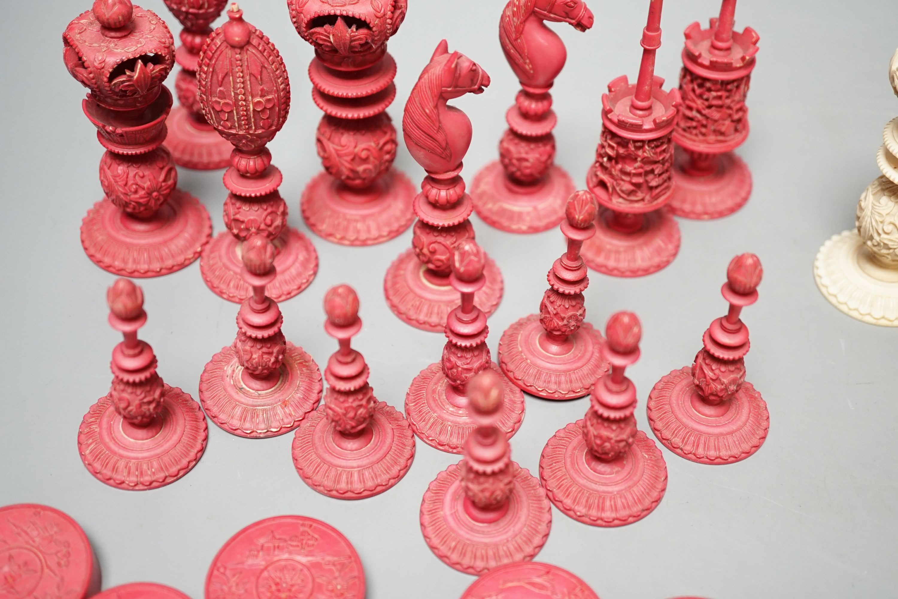 A 19th century Chinese export Burmese pattern carved and stained ivory chess set, one white pawn associated